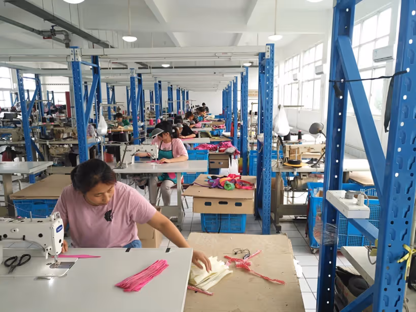 Sewing operators assembling pet collar webbing at the HappyPet Crafts collar workshop
