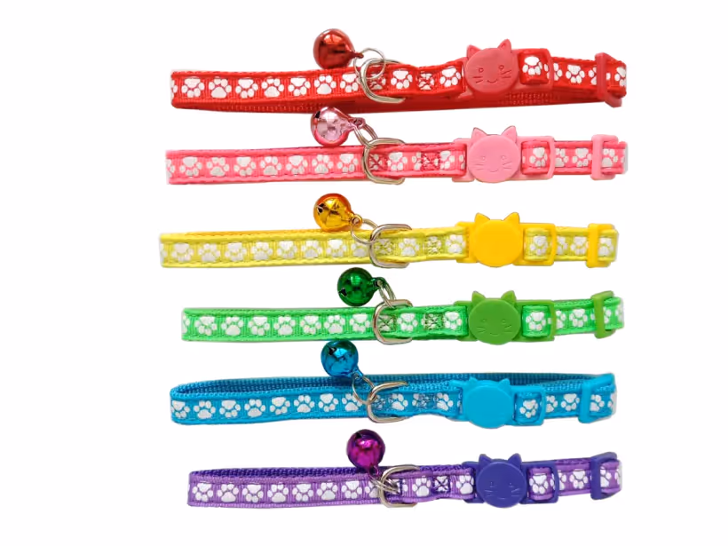 Six paw-print breakaway cat collars with cat-shaped buckles and bells in assorted colors