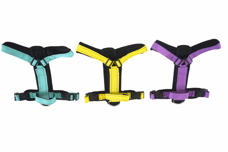 Three adjustable dog harness samples in teal, yellow and purple