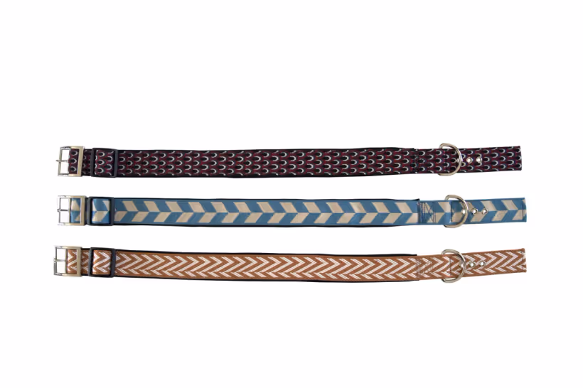 Three woven jacquard dog collars in burgundy, blue chevron and tan chevron patterns with metal buckles and D-rings