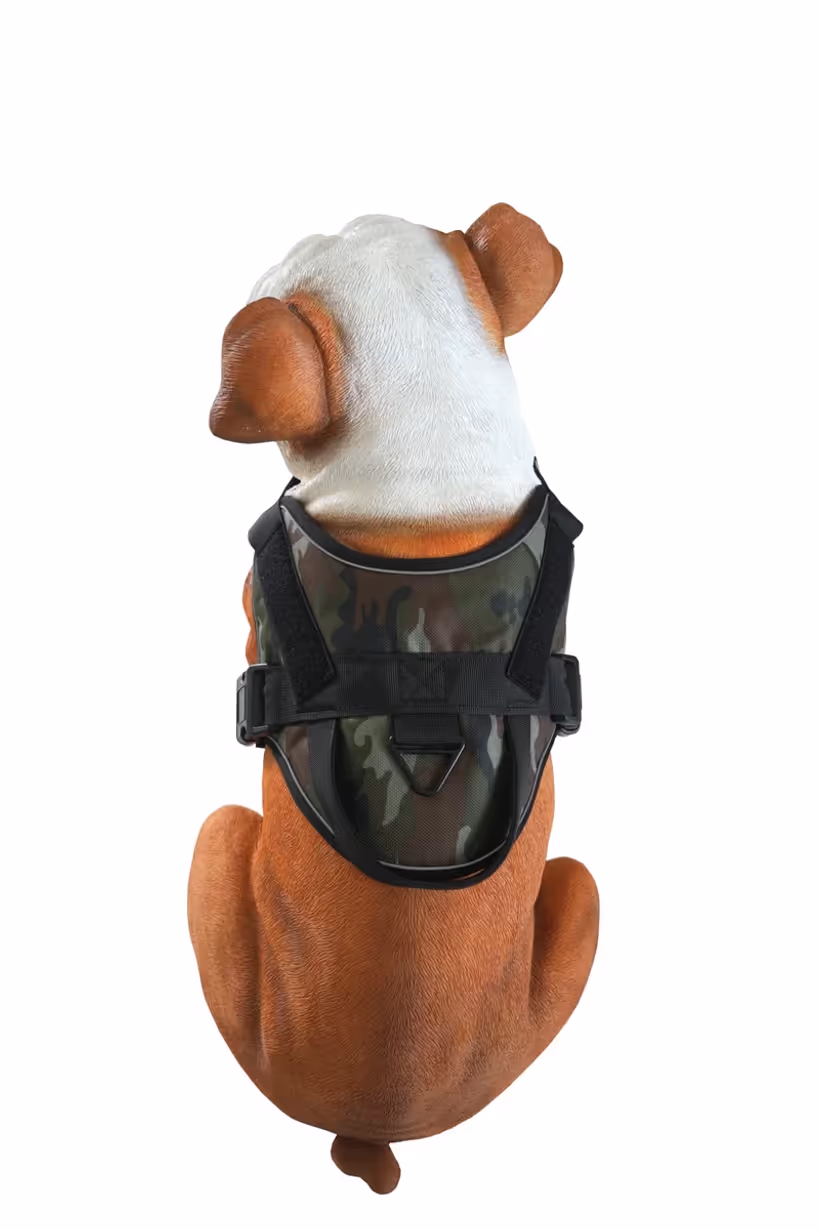 Camouflage tactical dog harness with hook-and-loop panels and handle shown on a bulldog display model